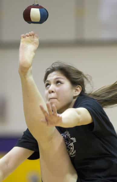 Julianna Wilson works to a win in the one-foot high kick event at the Kenaitze Indian Tribe's Native Youth Olympics Invitational at Kenai Middle School in January 2016.