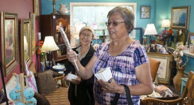 Nancy Nelson and Laura Hobson look at antiques in a curio store during a shopping trip. Both are participating in the tribe's Senior Companion Program.