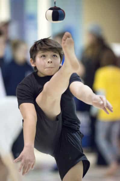 Kenaitze's William Wilson competes to a win in the boys junior division of the one-foot high kick event Saturday during the tribe's Native Youth Olympics Invitational at Mountain View Elementary School. Events continue Sunday at 9:30 a.m.