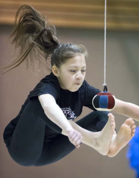 Kenaitze's Emilee Wilson competes Saturday morning in the two-foot high kick event at the tribe's Native Youth Olympics Invitational held at Mountain View Elementary School in conjunction with the Peninsula Winter Games.