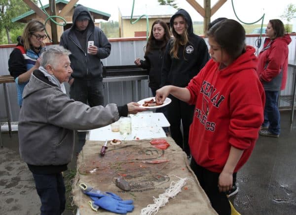 Mary Lou Bottorff offers smoked salmon to Julianne Wilson and other participants to sample at the end of the workshop. 