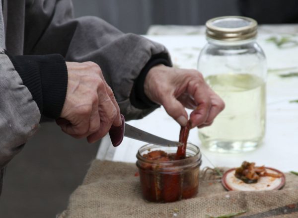 Mary Lou Bottorff pulls smoked salmon from a jar for participants to sample at the end of the workshop. 