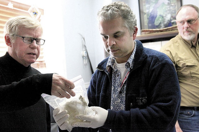 Dr. Alan Boraas and Dr. Ripan Malhi examine ancient human remains