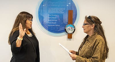 Evelyn Huf takes the oath of office as she is sworn in as Chief Judge of Kenaitze Tribal Court by Tribal Council Member Mary Ann Mills during a Council meeting in September. The ceremony took place in front of a plaque that recognizes Huf's father, Emil Dolchok, and other Tribal Elder's contributions to the Tribe.