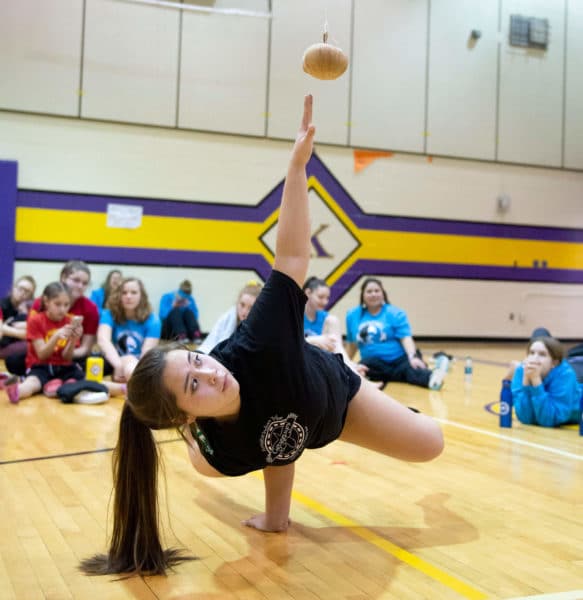 Kenaitze's Kya Ahlers competes in the one-hand reach event during the Tribe's annual Native Youth Olympics Invitational meet.