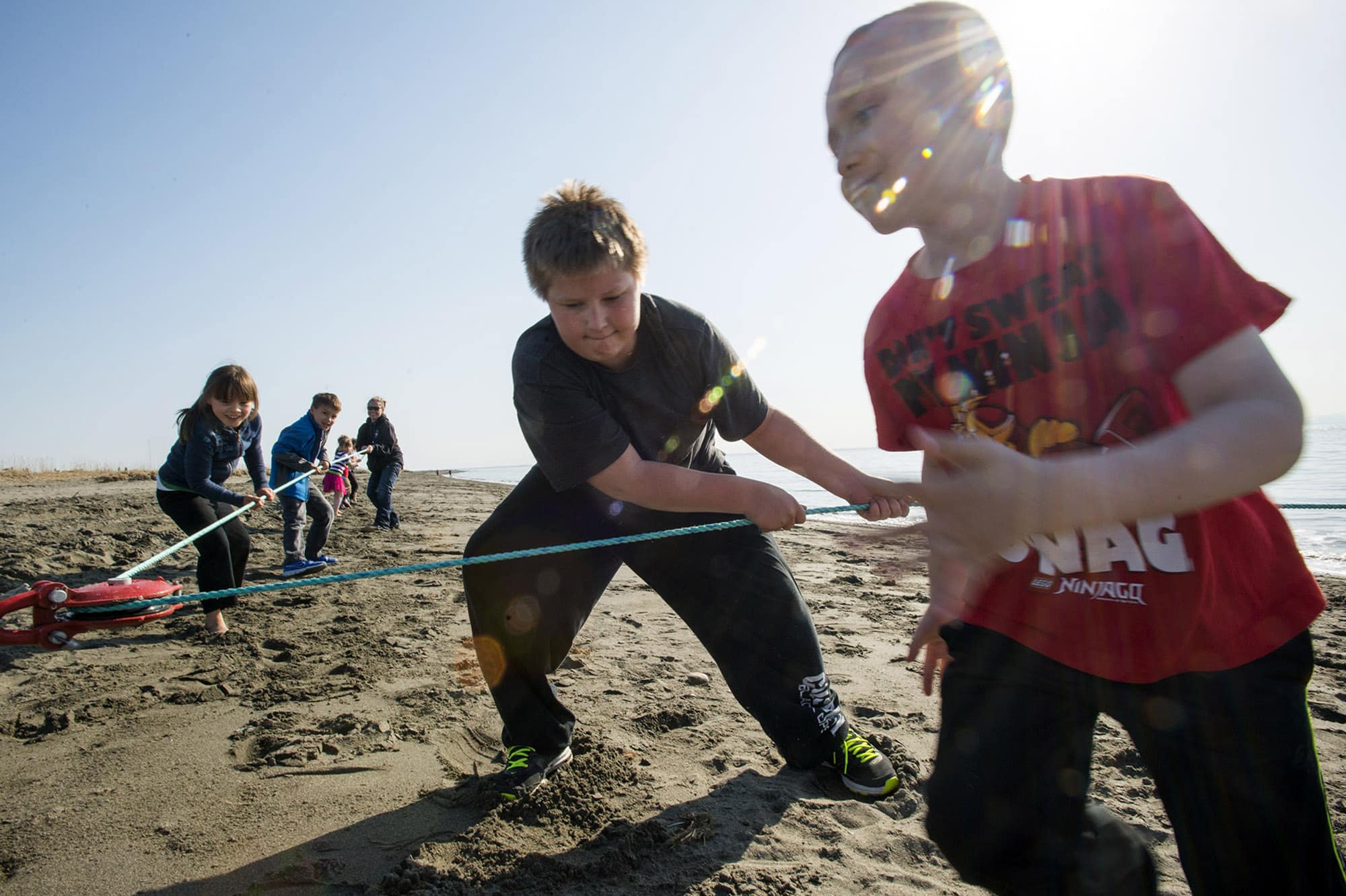 Children work together to pull in the tribe’s net.