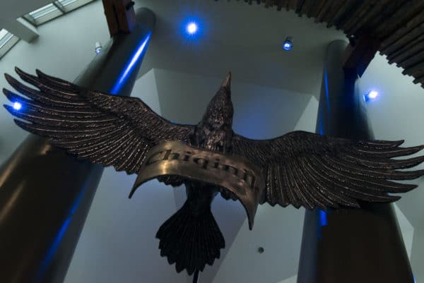 A raven in John Coyne's sculpture Dena'ina Rising holds the Dena'ina word for thank you - chiqinik. The artwork is inside the Dena'ina Wellness Center.