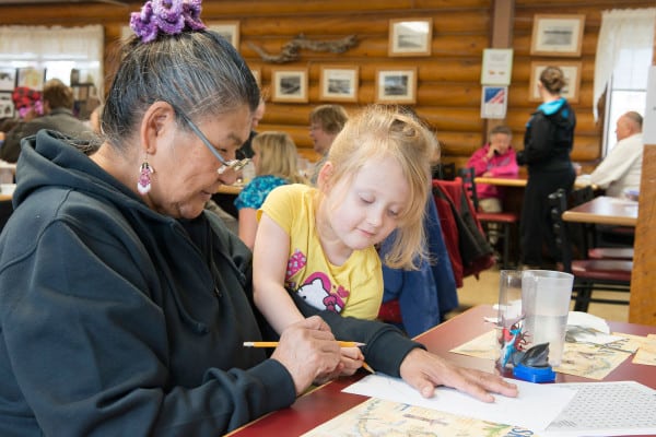 OUR VALUES: EDUCATION-Elder Barbara Kinzy helps Kaydence Kline-Samson with a word puzzle at Tyotkas Elder Center. Kaydence was at the center with others from her class at the Early Childhood Center.