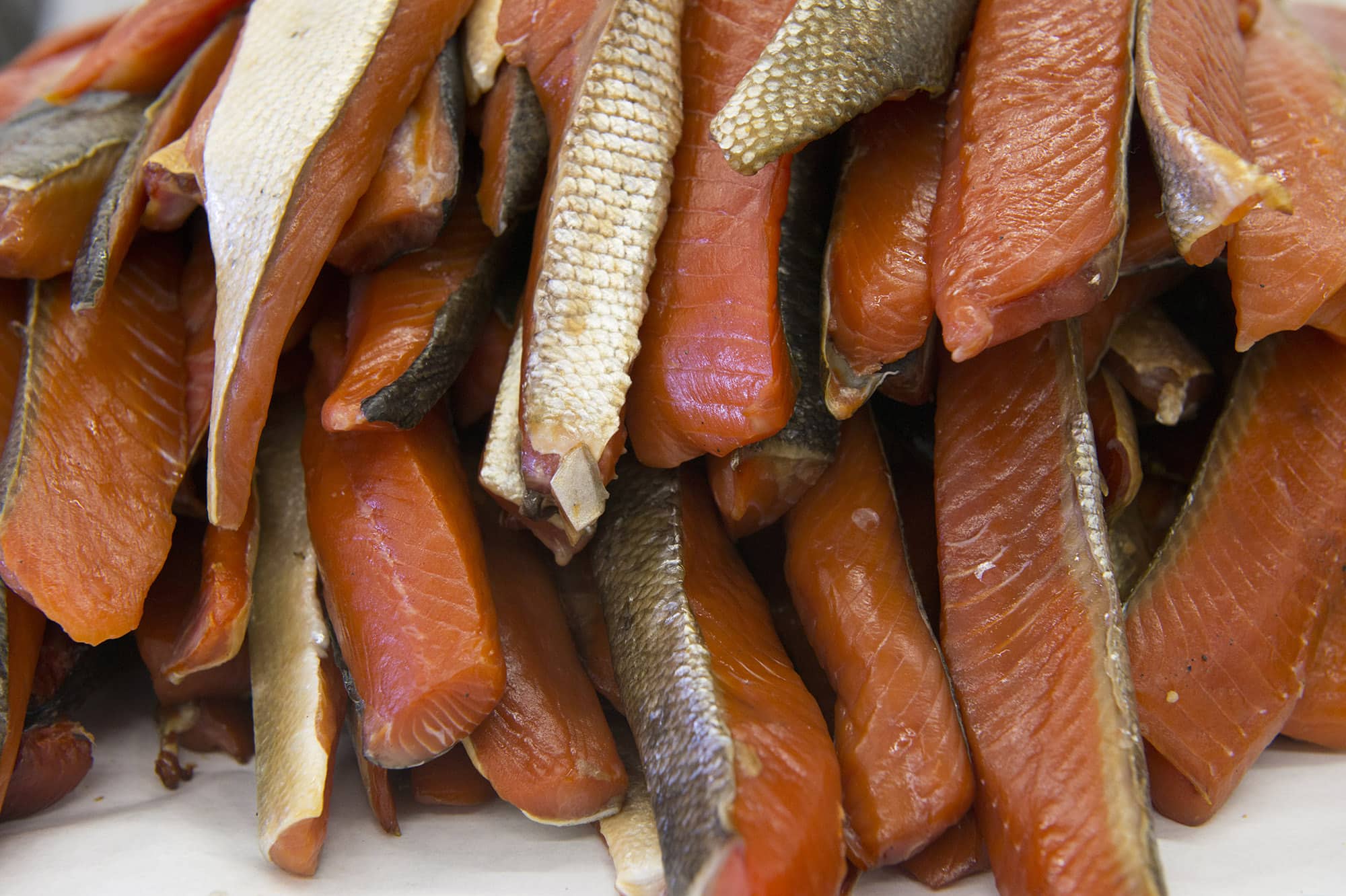 Smoked salmon, harvested from the tribal net, will be cut and canned.